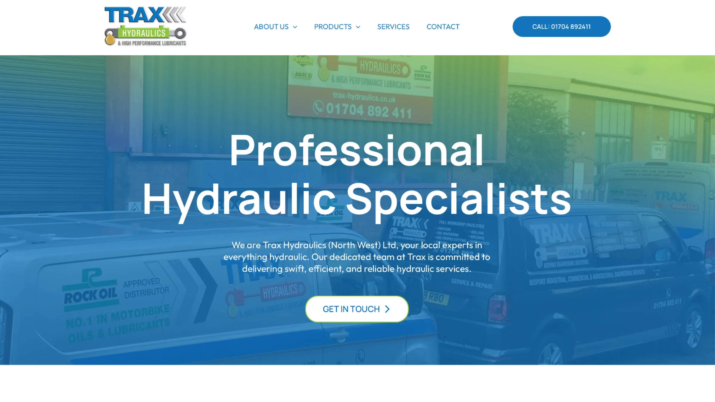 Trax Hydraulics homepage hero — Professional Hydraulic Specialists, with the company's branded vehicles and depot in the background